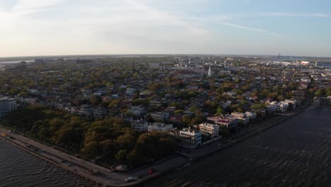 aerial descending and panning shot of white point garden at oyster point during sunset in charleston, south carolina