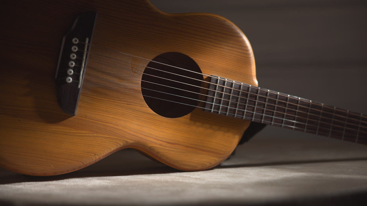Moody Studio Shot Acoustic Guitar Resting On Tabletop With Soft Shadows Shallow Focus And Cinematic Warm . Media