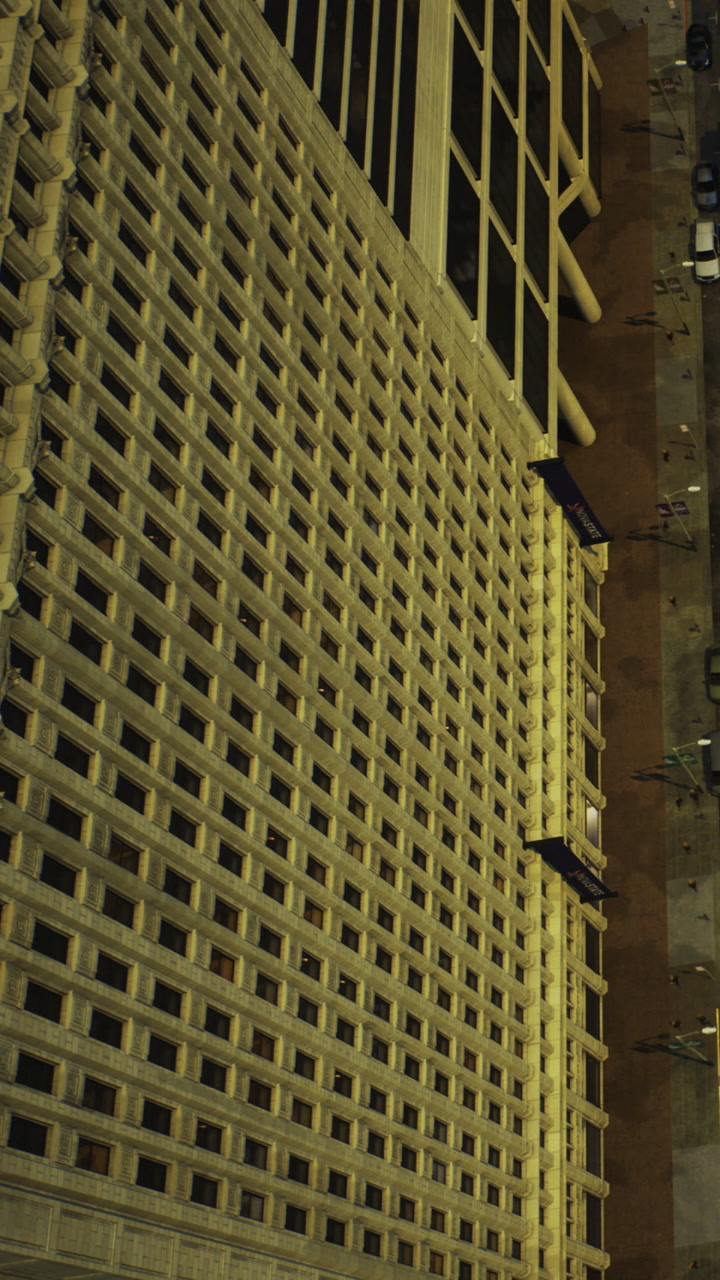 View from above of a tall building and surrounding street area in the city