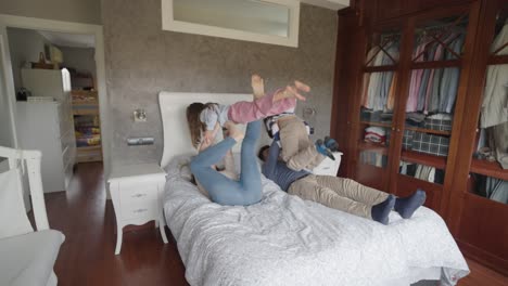 family playing and having fun on the bed