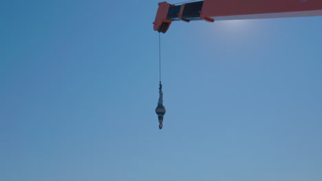 crane at barrons boatyard at city island in new york on a sunny day with hart island in the background