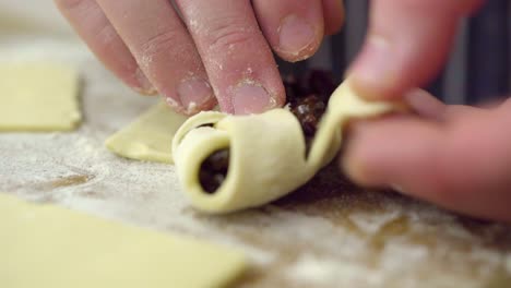 someone is wrapping fruit up in a pastry