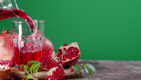 the juice of ripe pomegranate is poured into a glass.