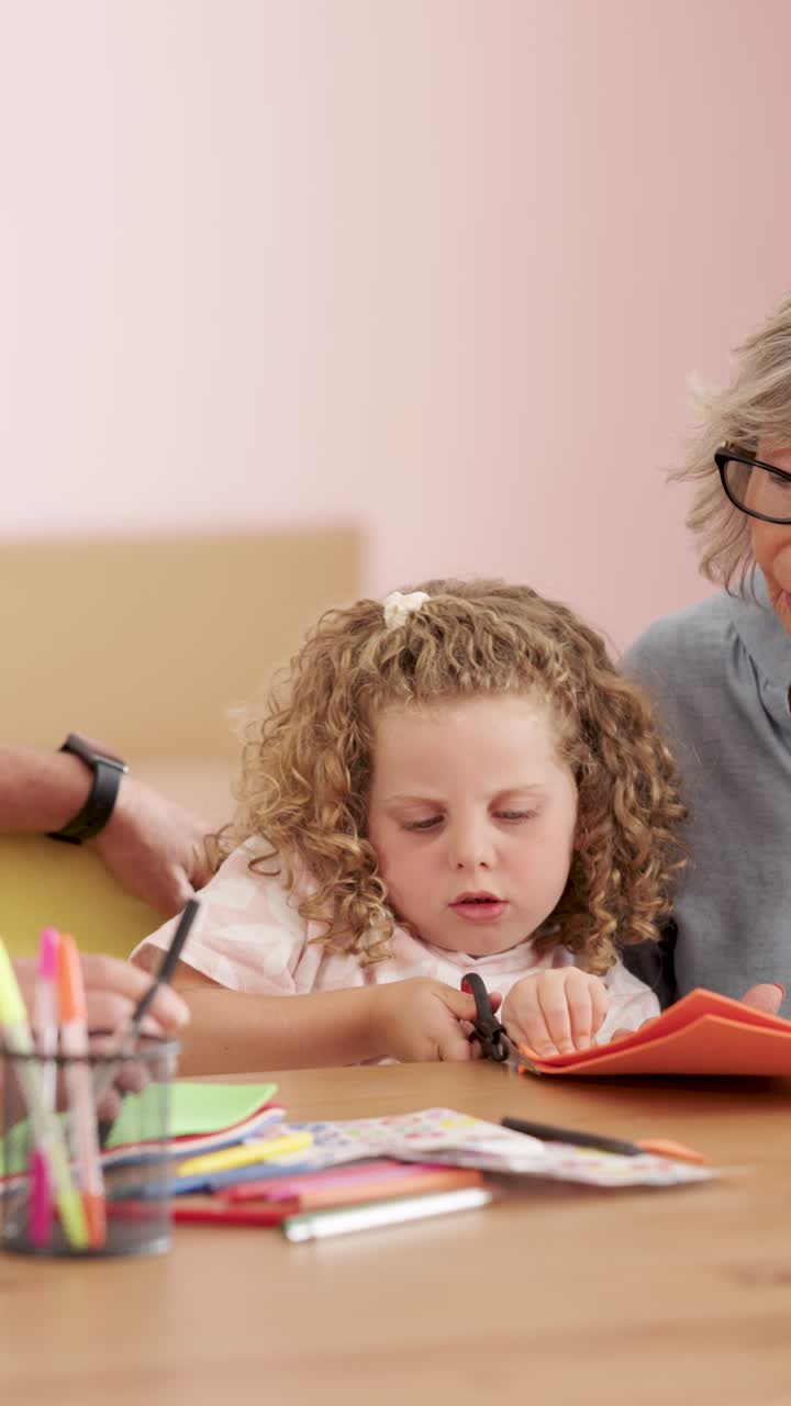 Grandmother helping child with crafts