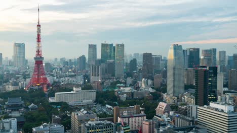 day to night time-lapse of tokyo city downtown district with tokyo tower, evening cityscape view. japan tourist attraction landmark or asia travel destination concept