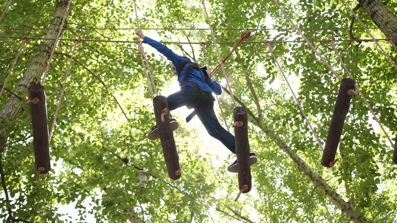 Child enjoying a treetop adventure course