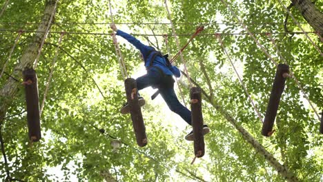 child enjoying a treetop adventure course