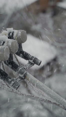 satellite dish in snow. satellite dish frozen hanging on front cottage wall in a snowy winter outdoors. vertical video