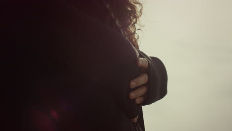 couple hands hugging together outdoors. two lovers touch body gently on sunset.