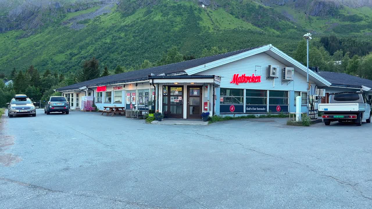 Traditional expensive grocery franchise store in a small village in Northern Norway with a Petrol pump to fuel up cars