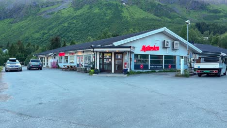 traditional expensive grocery franchise store in a small village in northern norway with a petrol pump to fuel up cars