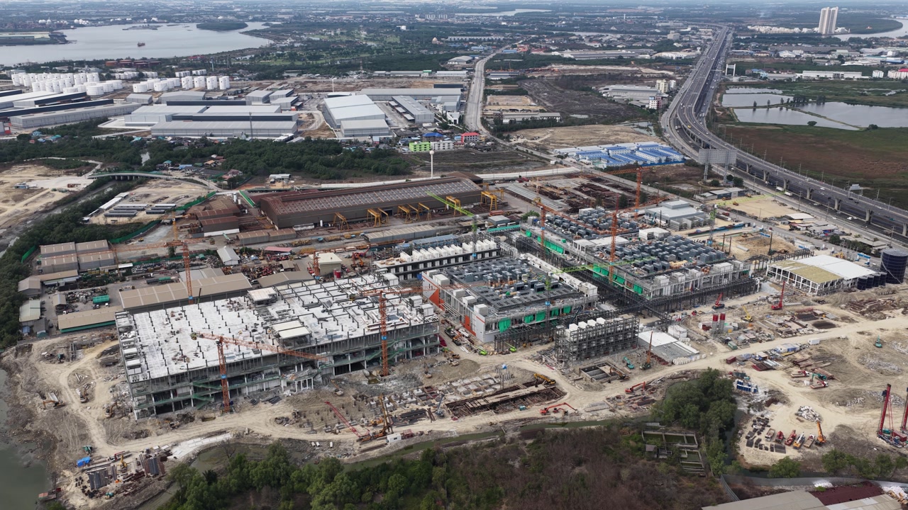 Aerial drone video of Data Centre QHI01 hyperscale campus construction in Chonburi, Thailand, within the Eastern Economic Corridor, showing large scale cloud computing, AI infrastructure, and
