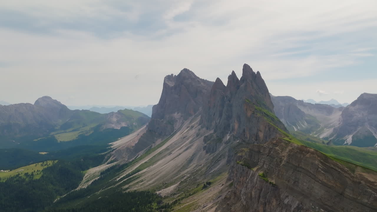 Spectacular aerial footage of the Seceda ridgeline in the Dolomites, showcasing its dramatic jagged peaks, rolling meadows, and panoramic alpine views