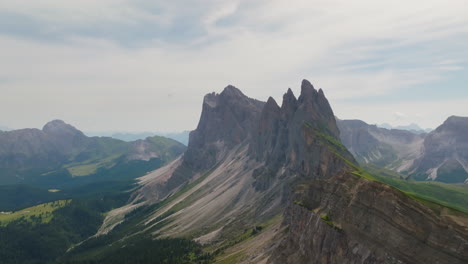 spectacular aerial footage of the seceda ridgeline in the dolomites, showcasing its dramatic jagged peaks, rolling meadows, and panoramic alpine views