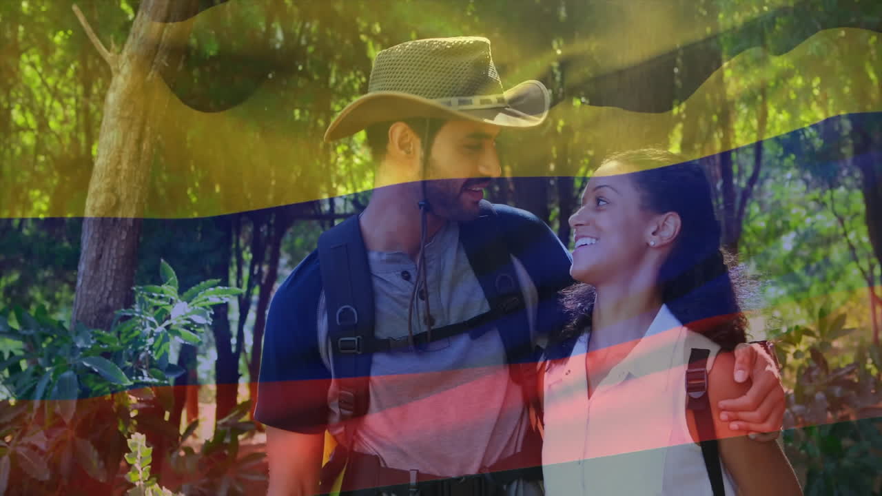 Hiking in forest, couple carrying Colombian flag colors overlay in animation