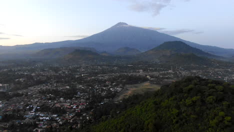 aerial view of a huge mountain looming in the distance from a rural village in tanzania