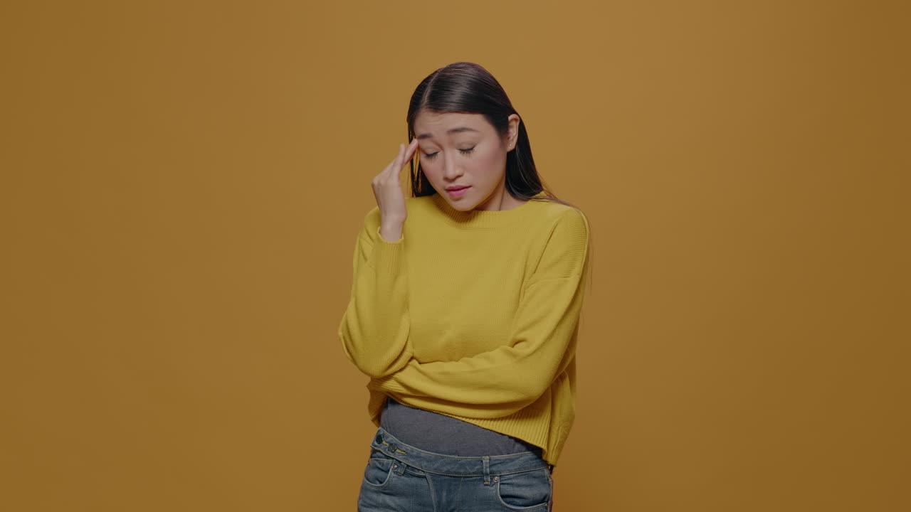 Asian woman feeling worried and emotional on camera