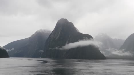 heavy fog over the milford sound (piopiotahi), fiordland national park on the south island of new zealand.