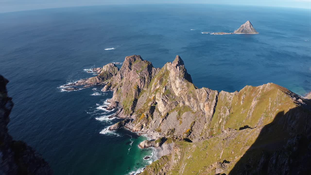 Stunning aerial view over Måtinden, showcasing lush green hills and a distant ocean view