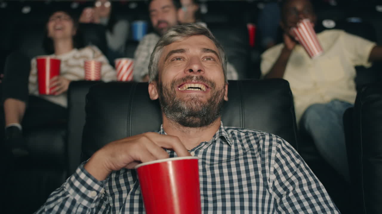 Audience Laughing at Movie in Theater