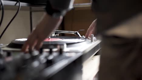 High-Definition-panning-shot-of-DJ-spinning-vinyl-on-turn-table