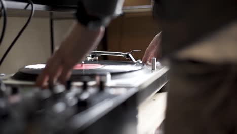 high-definition-schwenkaufnahme eines djs, der vinyl auf dem plattenteller dreht