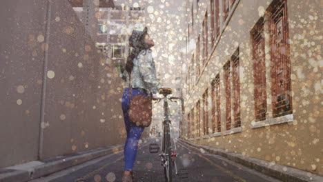 animation of light spots over biracial woman walking with bicycle