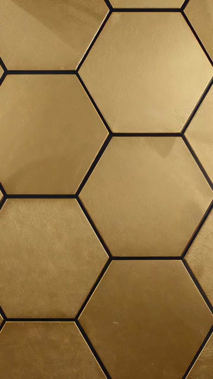 Vertical video: Panning camera revealing gold hexagon tiles on backsplash showing shadow and scuffs