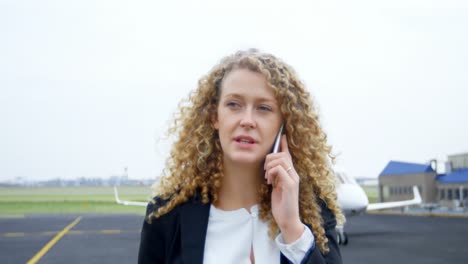 mujer de negocios hablando por teléfono móvil en la terminal 4k