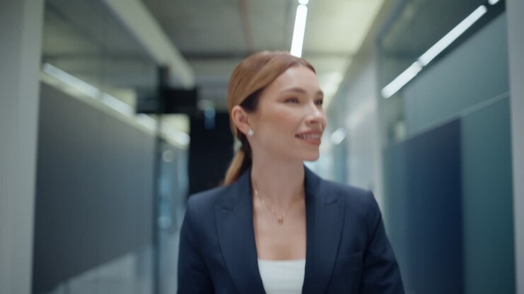 Friendly office manager greeting colleagues on go closeup. Smiling business lady