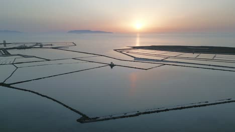 aerial drone fly saline di trapani italian natural reserve at sunset salt fields