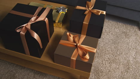 close up of gift wrapped presents on table in lounge at home 5