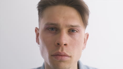 blond man wearing denim shirt, looking at front