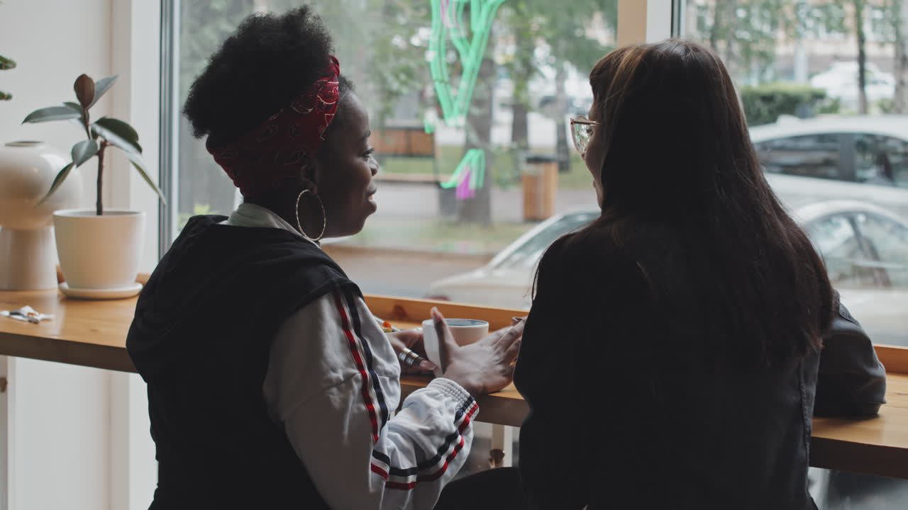 Lesbian Couple Having Conversation in Cafe