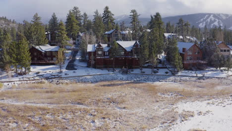 coming home to big bear california mansion outskirts aerial snow covered mountains drone