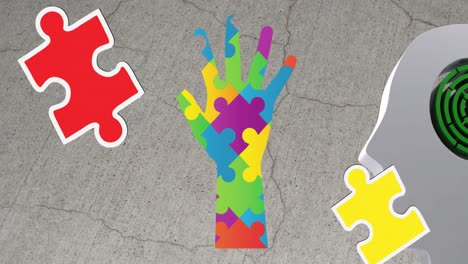 Animation-of-autism-colourful-puzzle-pieces-forming-hand-and-head-with-labyrinth