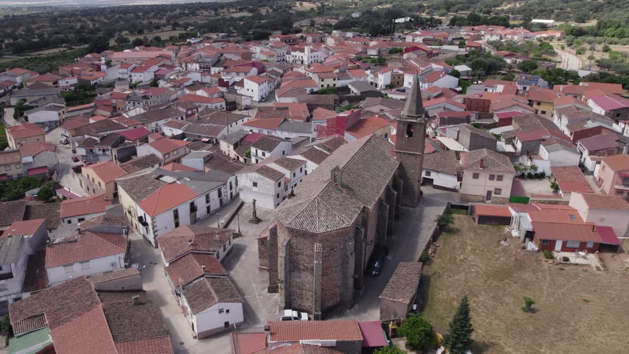 Aerial view orbiting Tejeda de Ti&eacute;tar parish church of San Miguel and traditional Spanish red brick townscape