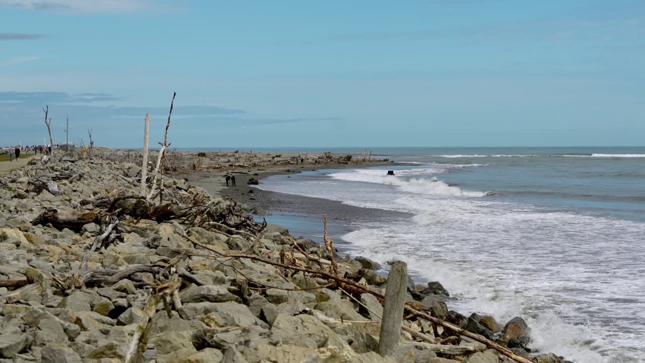 Static Slow-mo of Hokitika Beach with waves and drift wood - New Zealand