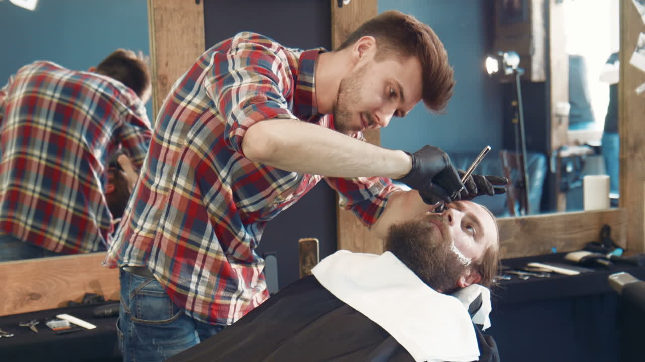 Barber Shaving Customer in a Barber Shop