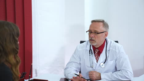 medic consults patient in clinic office. male doctor and female patient discussing methods of health issues treatment. health care concept. consultation in clinic.