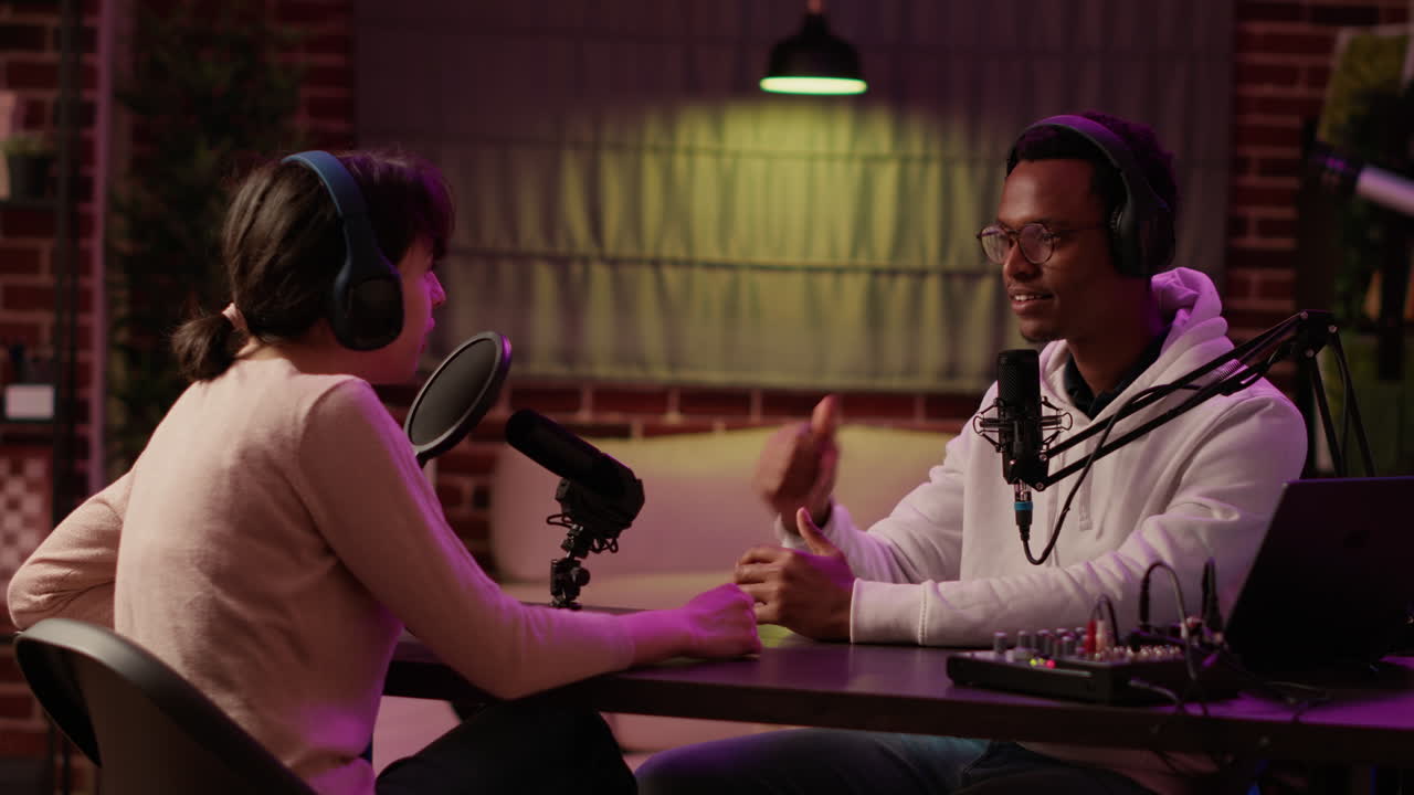 African american internet show host interviewing famous influencer while adjusting headphones