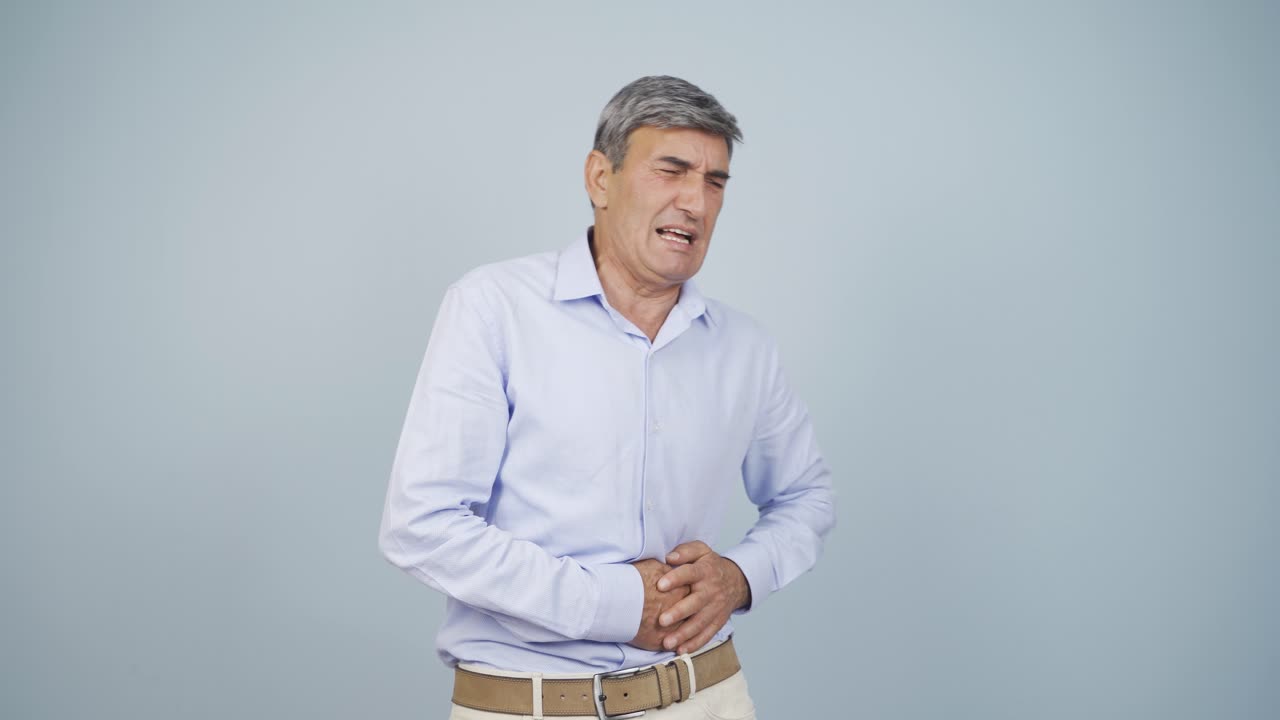 Old man experiencing stomachache.