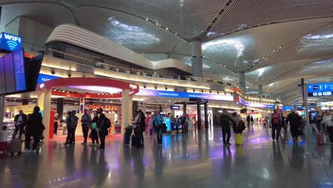 people walking through an airport terminal