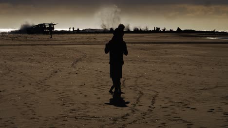 Dad-and-kids-on-a-sunset-walk-by-the-beach---Snapper-Rocks-Gold-Coast-Australia