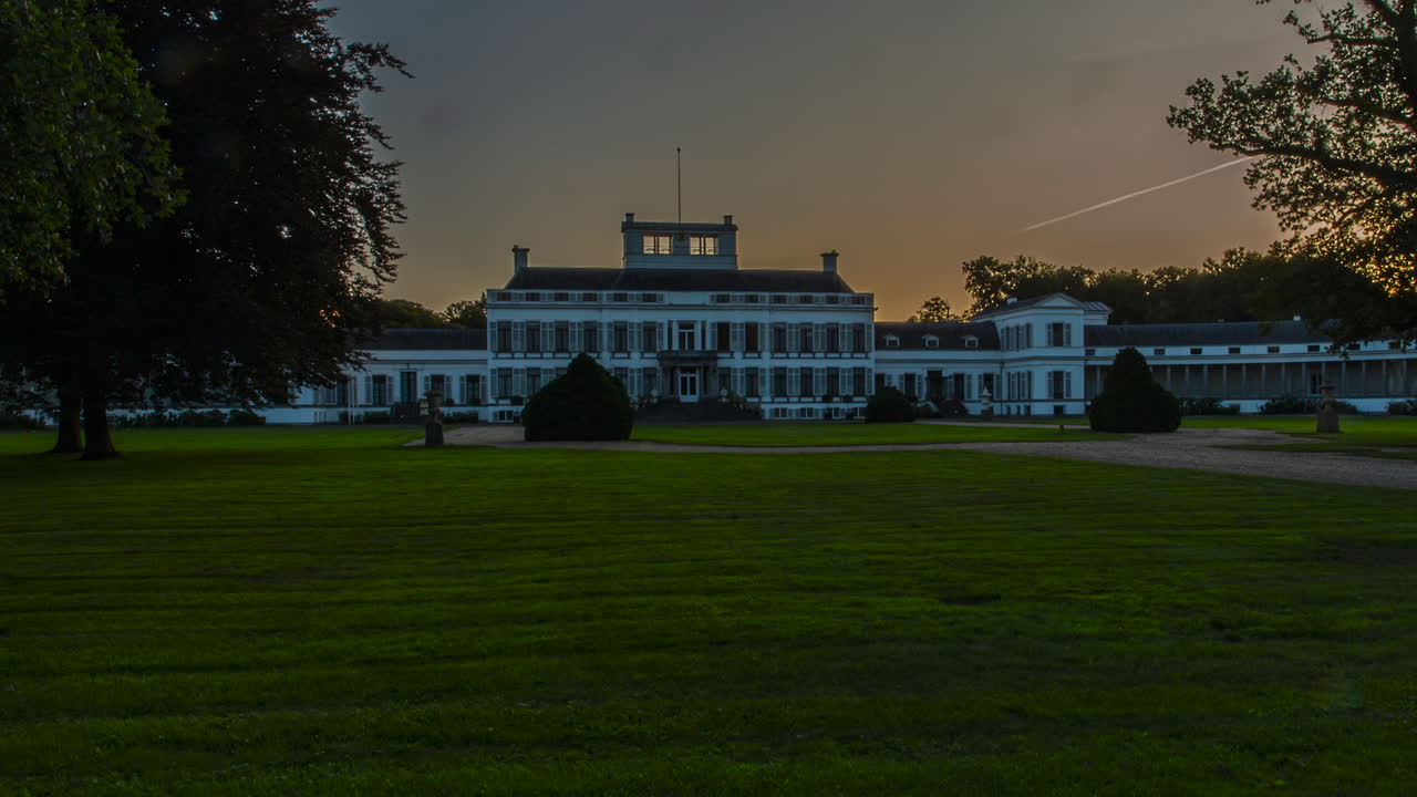 Time lapse of a beautiful old palace while the sun is setting - zoom in