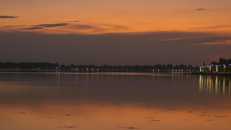 sunset timelapse in front of a large lake forshore road