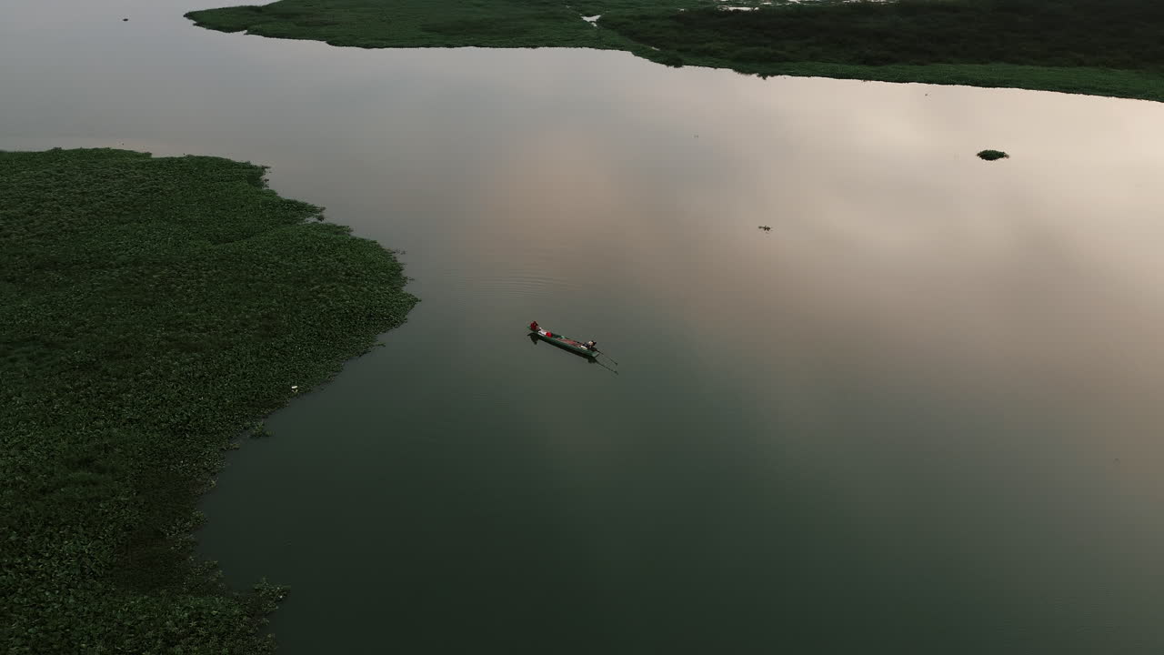 Fishing Boat on a Calm Lake at Sunset