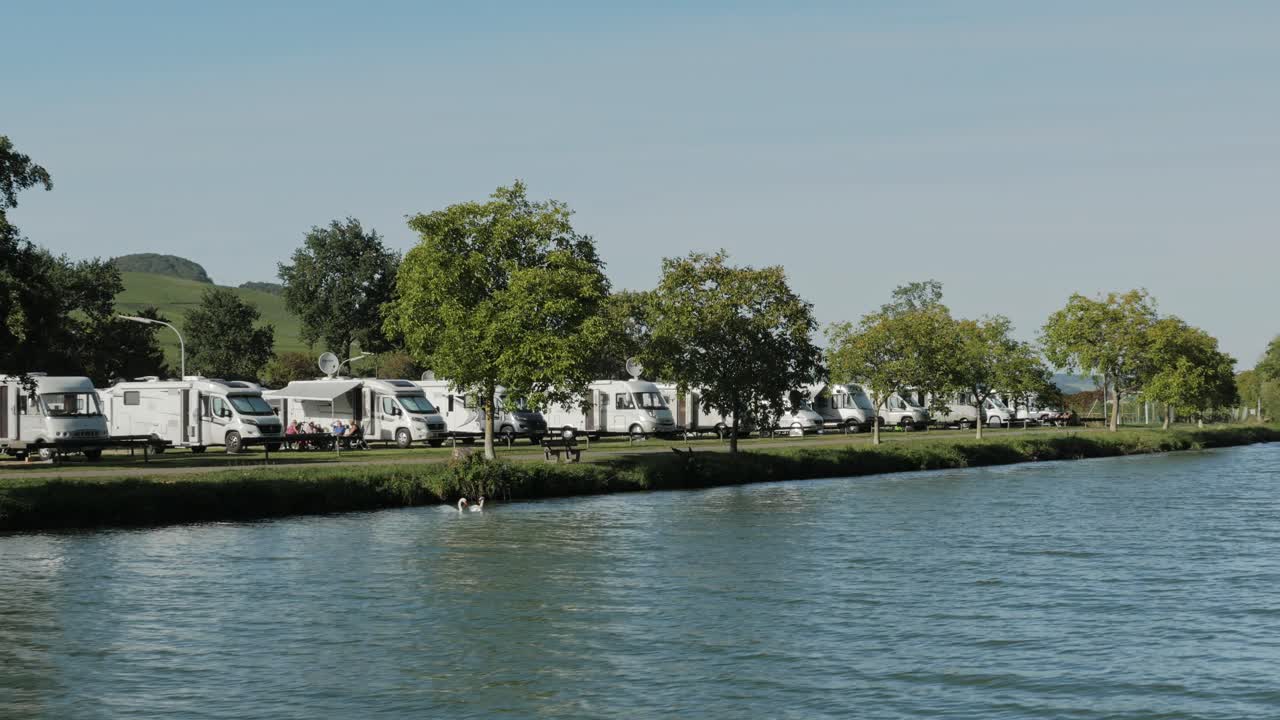 Motorhomes Parked by a River