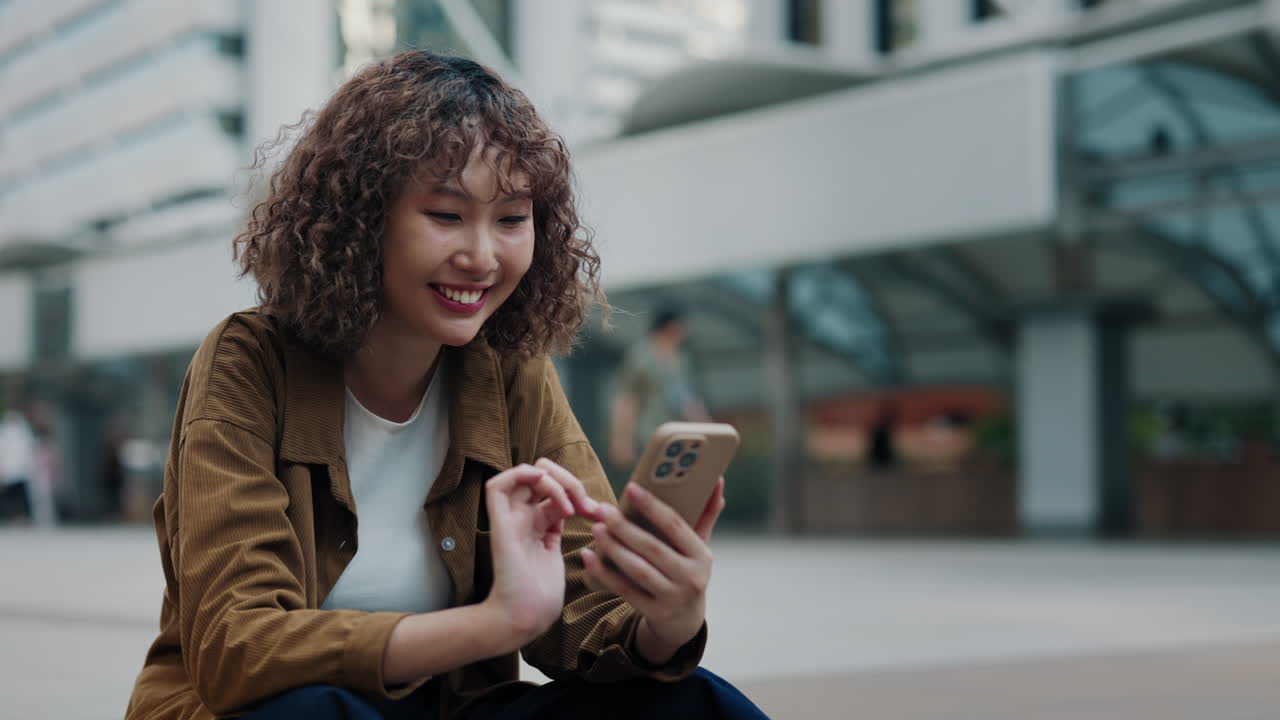 Woman using smartphone in city