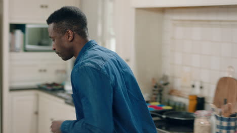 happy-african-american-man-dancing-in-kitchen-having-fun-dance-celebration-enjoying-weekend-at-home